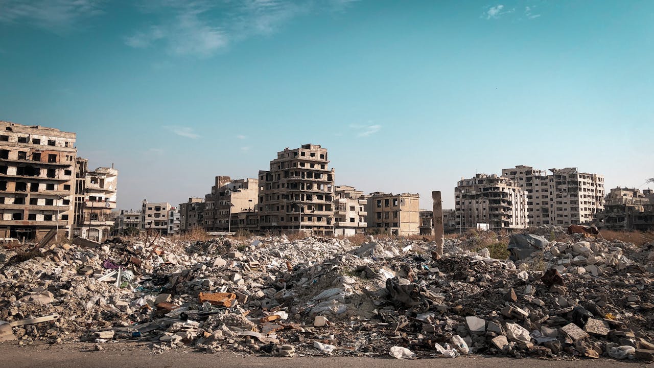 home-img View of demolished buildings and rubble in Homs, Syria post-conflict.