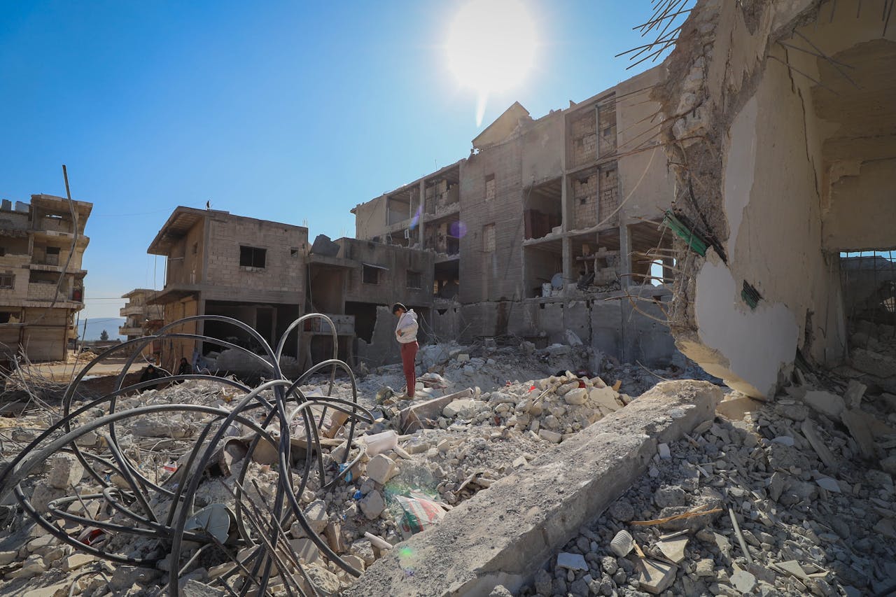 our-story A destroyed urban area in Idlib, Syria depicting the aftermath of conflict and devastation.