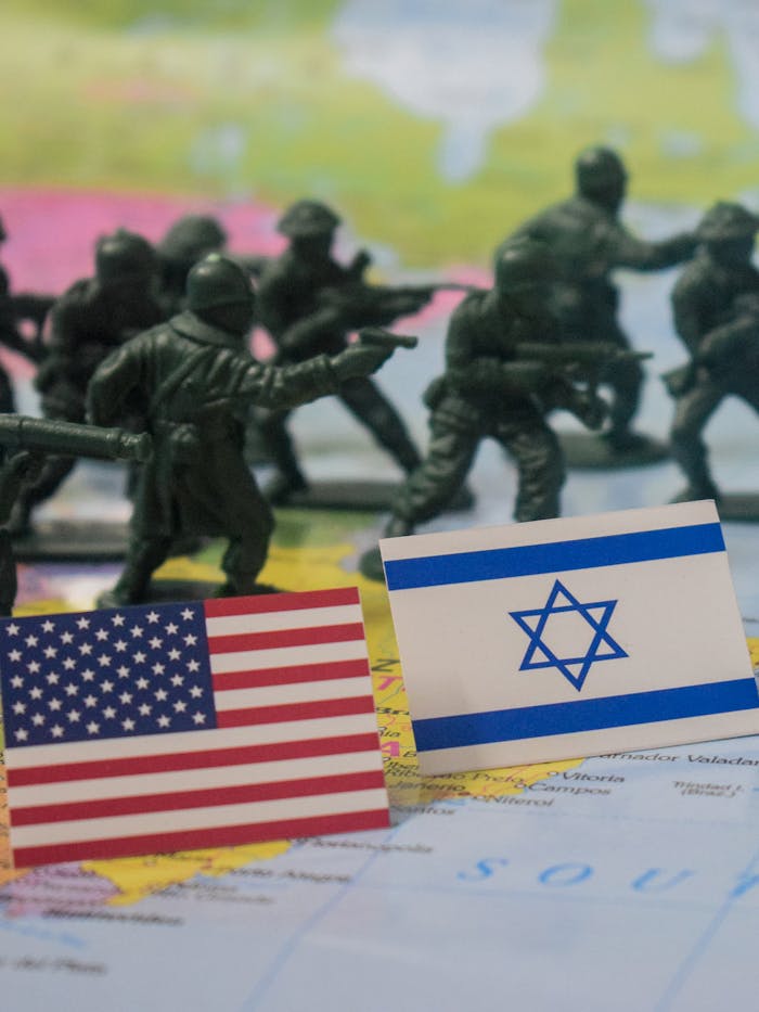 gallery-01 Miniature army figures with USA and Israel flags on a world map signifying military strategy.